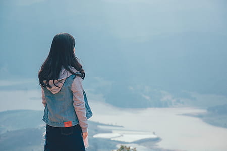 Woman in Gray and Blue Zip-up Hoodie Standing on the Cliff thumbnail