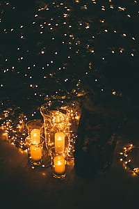 photo of votive candles near Christmas tree thumbnail