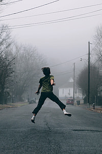 boy jumping in the middle of road thumbnail