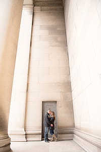 Man and Woman Kissing Inside Building Near Door thumbnail