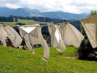 white long-sleeved blouse on clothes rack during daytime thumbnail