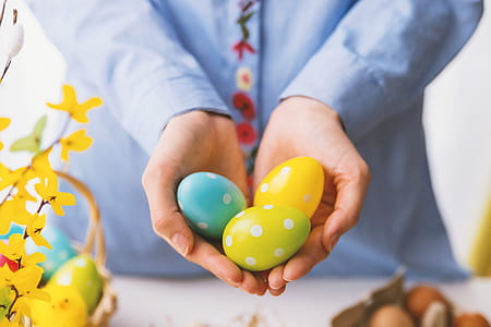 Hands holding modern painted easter eggs. thumbnail