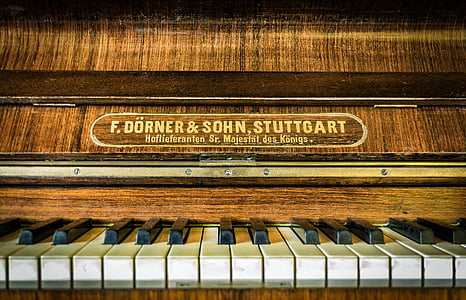 macro photography of brown wooden upright piano thumbnail