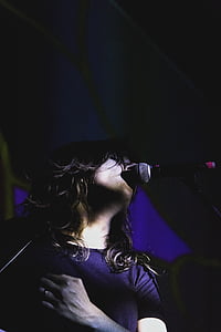 standing woman singing with microphone thumbnail