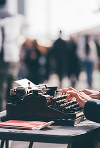 person typing using typewriter thumbnail