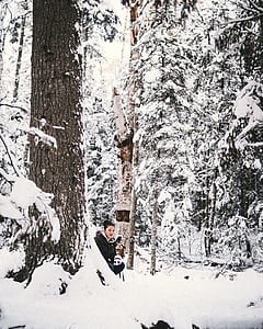 woman wearing black coat sitting near the tree thumbnail
