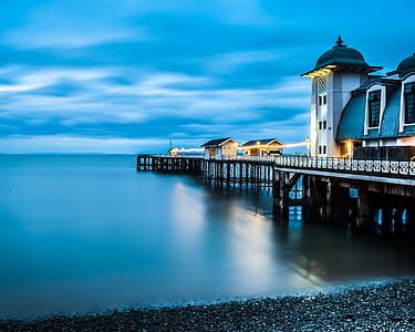 gray and brown house on dock during daytime thumbnail