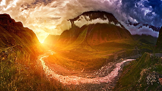 body of water surrounded by mountains thumbnail