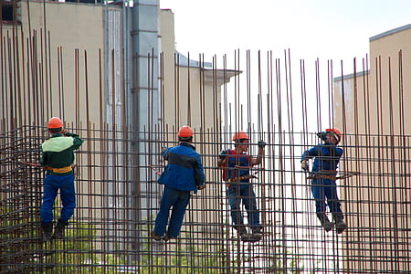 people hanging on grey metal scaffolding thumbnail