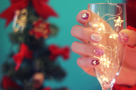 woman holding wine glass with string light thumbnail
