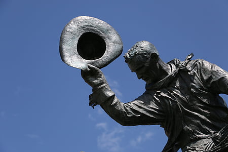 man holding hat statue thumbnail