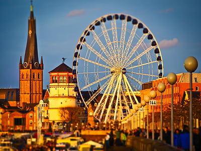 Ferris wheel and buildings under clear blue sky thumbnail