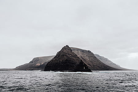 gray rock formation in middle of ocean thumbnail