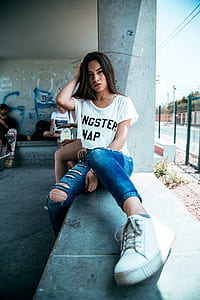 woman in white short-sleeved shirt holding hair during daytime thumbnail