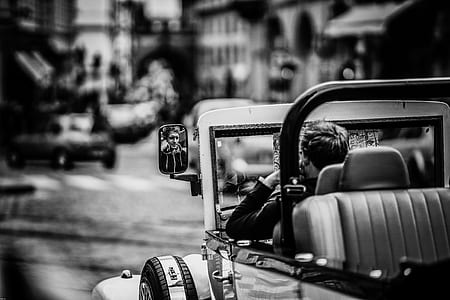 grayscale photo of person riding on vehicle thumbnail