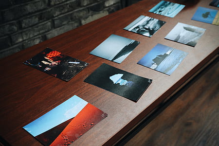 assorted photos on brown table thumbnail