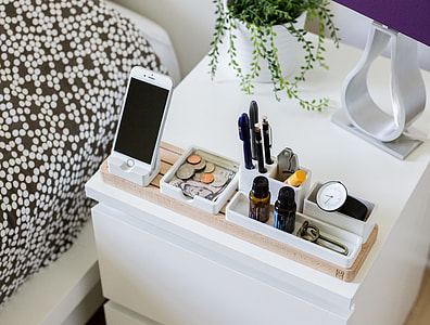 silver iPhone 6 beside coins and twist pen on top of side table thumbnail