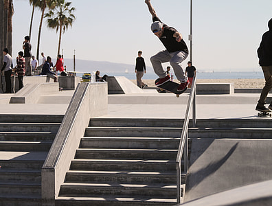 people on gray park with tracks and ramps skateboarding during daytime thumbnail