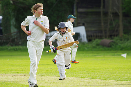 woman running on the field holding cricket bat thumbnail