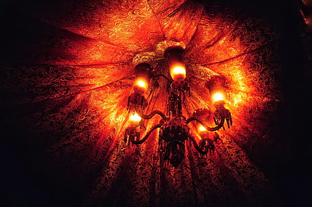 orange uplight chandelier under textile thumbnail