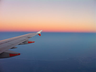 flying airplane showing right wing on the sky thumbnail