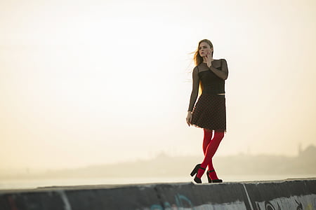 woman standing on gray concrete wall thumbnail