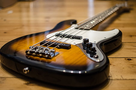 black, brown, and white 4-string bass guitar thumbnail