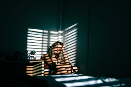 woman sitting on bed thumbnail