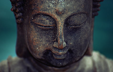 brass-colored buddha face statue thumbnail
