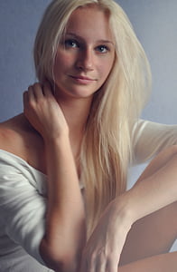 blonde-haired woman wearing white off-shoulder elbow-sleeved shirt inside well-lit room thumbnail