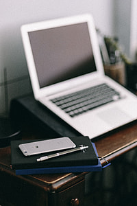 Elegant workspace with Macbook, iPhone, business cards and notebooks thumbnail