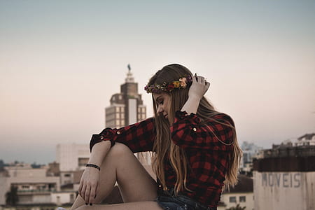 woman wearing flower crown with high-rise building background thumbnail