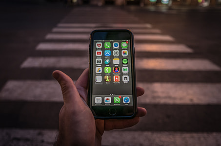 person holding turned on space gray iPhone 6 thumbnail