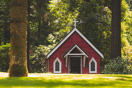 Red Chapel on Grassy Field With Trees thumbnail