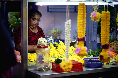 woman making flower leis thumbnail