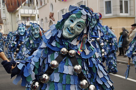 person wearing blue and green costume while standing at daytime thumbnail