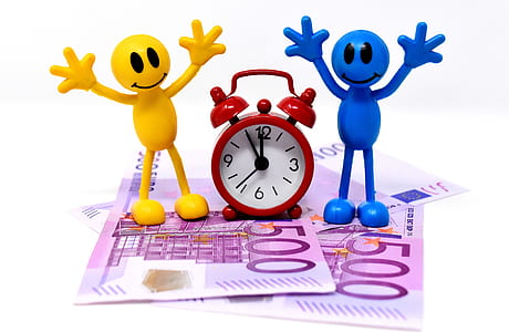 red bell alarm clock on banknote thumbnail