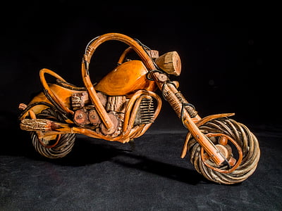 brown wooden miniature motorcycle with black background thumbnail