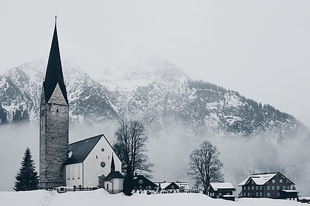 white chapel surrounded with town houses under winter season thumbnail