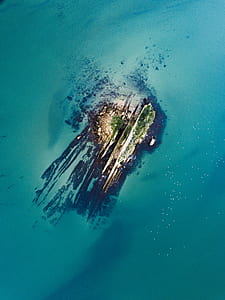 aerial view of island near ocean during daytime thumbnail
