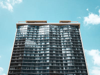 grey and black building under teal sky thumbnail