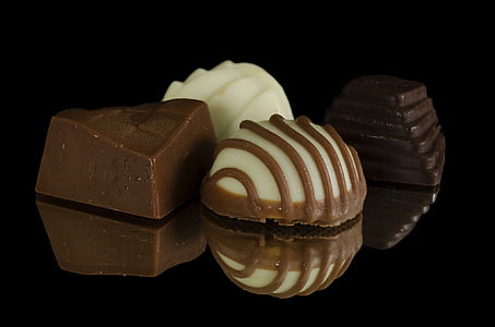 four chocolates on black surface thumbnail