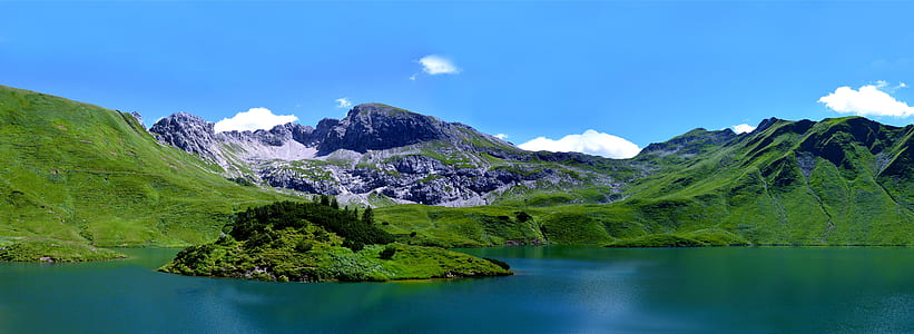 body of water beside green mountain thumbnail