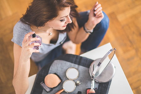 woman spray perfume on her body thumbnail