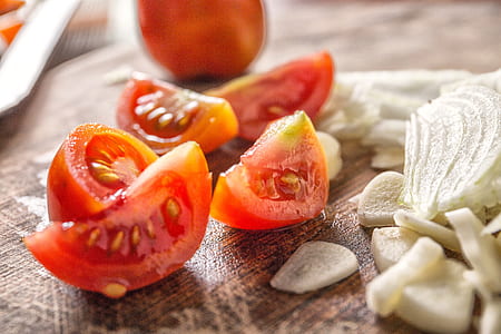 four sliced tomatoes near onions thumbnail