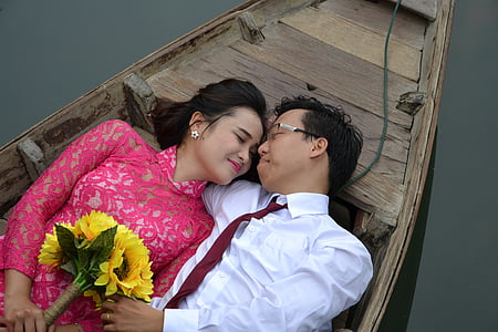 man and woman lying on brown boat thumbnail