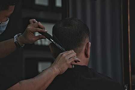 man cutting hair of man thumbnail