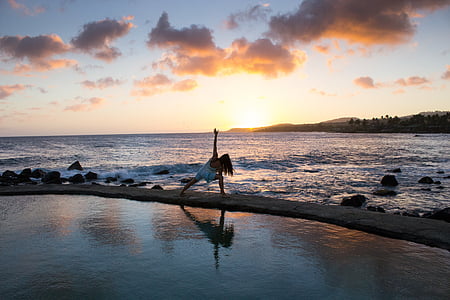 woman doing yoga in front of sea thumbnail