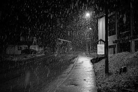 grayscale photography of snow falling on road thumbnail