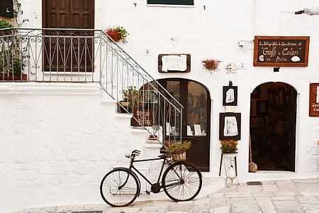 black city bike beside wall thumbnail